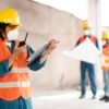 Construction Health and Safety UK guide showing workers wearing PPE on a construction site