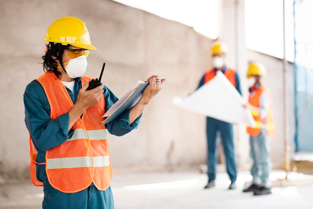 Construction Health and Safety UK guide showing workers wearing PPE on a construction site