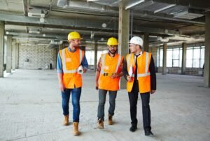 Site Safety Responsibilities UK construction workers wearing PPE on a building site